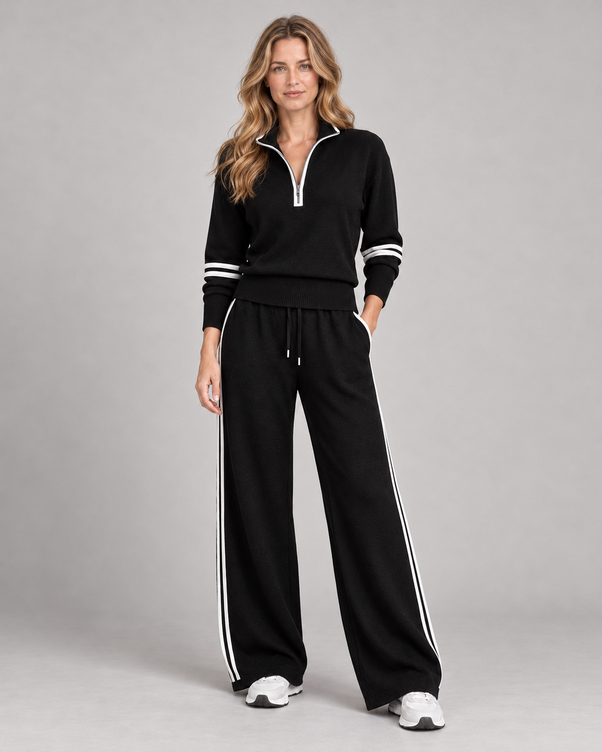 Black knitted quarter-zip jumper and wide-leg trousers, front view on Ellis & Rowe model