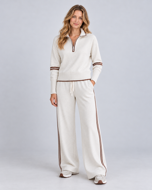 White knitted quarter-zip jumper and wide-leg trousers, front view on Ellis & Rowe model