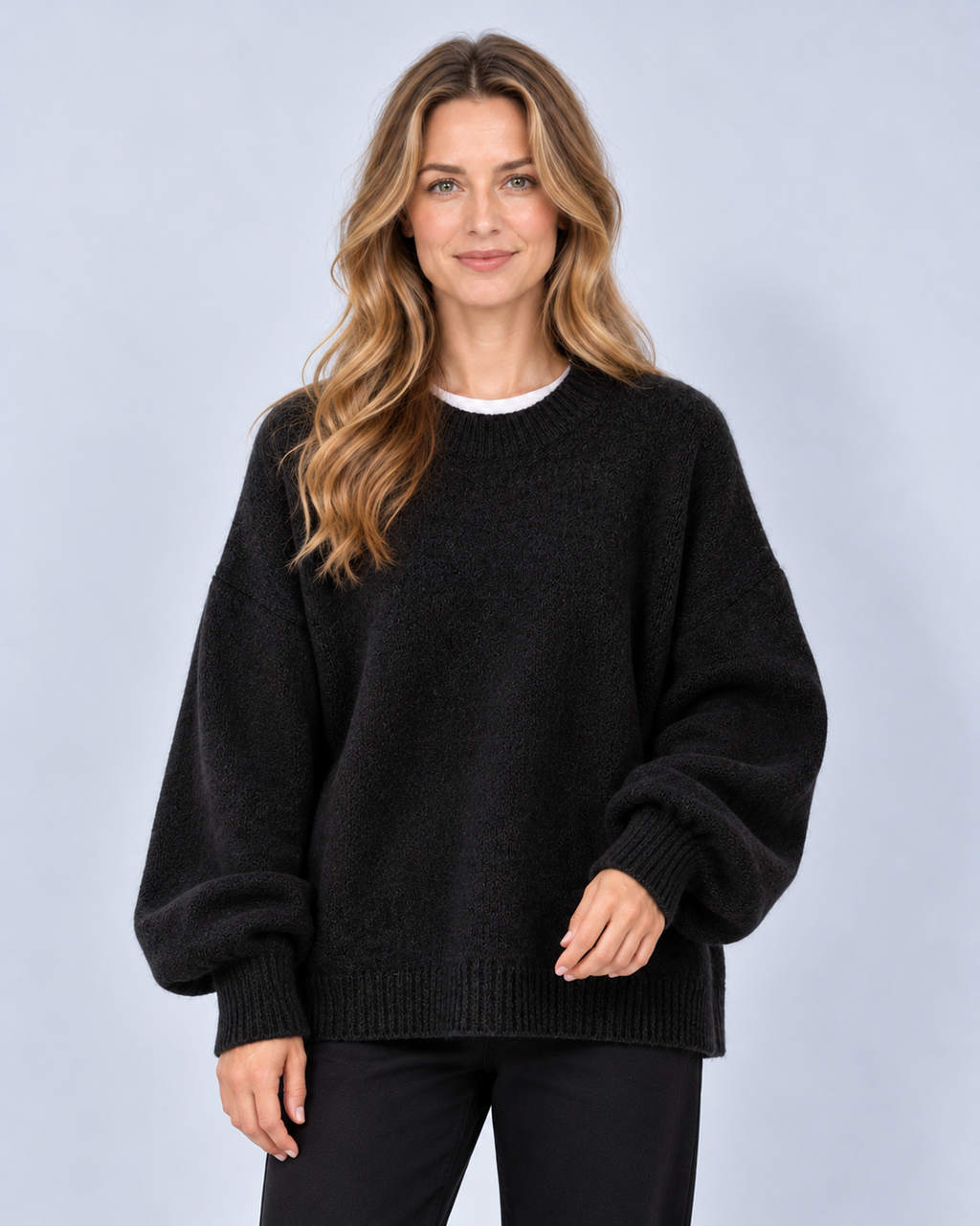 Women's round neck drop shoulder split hem jumper, black front, studio model photograph