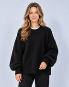 Women's round neck drop shoulder split hem jumper, black front, studio model photograph