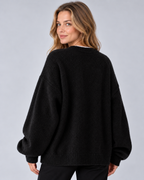 Women's round neck drop shoulder split hem jumper, black rear, studio model photograph