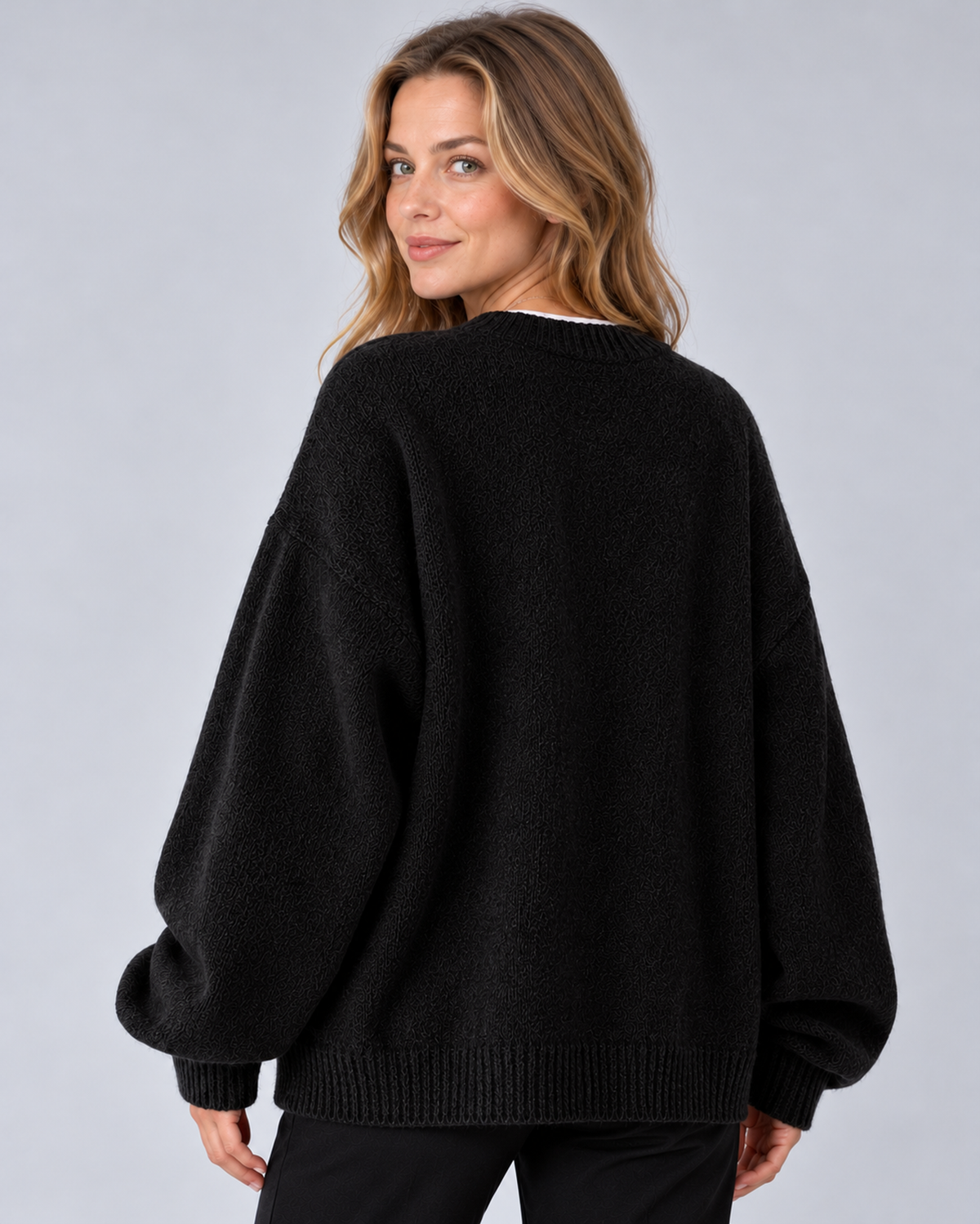 Women's round neck drop shoulder split hem jumper, black rear, studio model photograph
