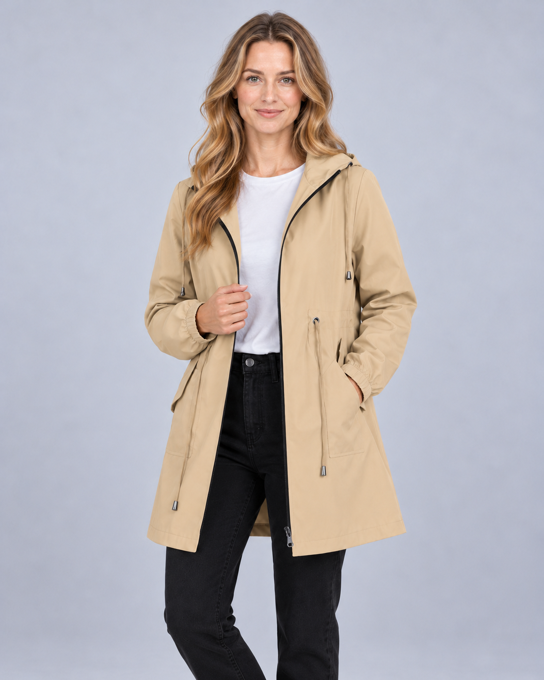 Women's lightweight hooded rain coat in beige, front view on model