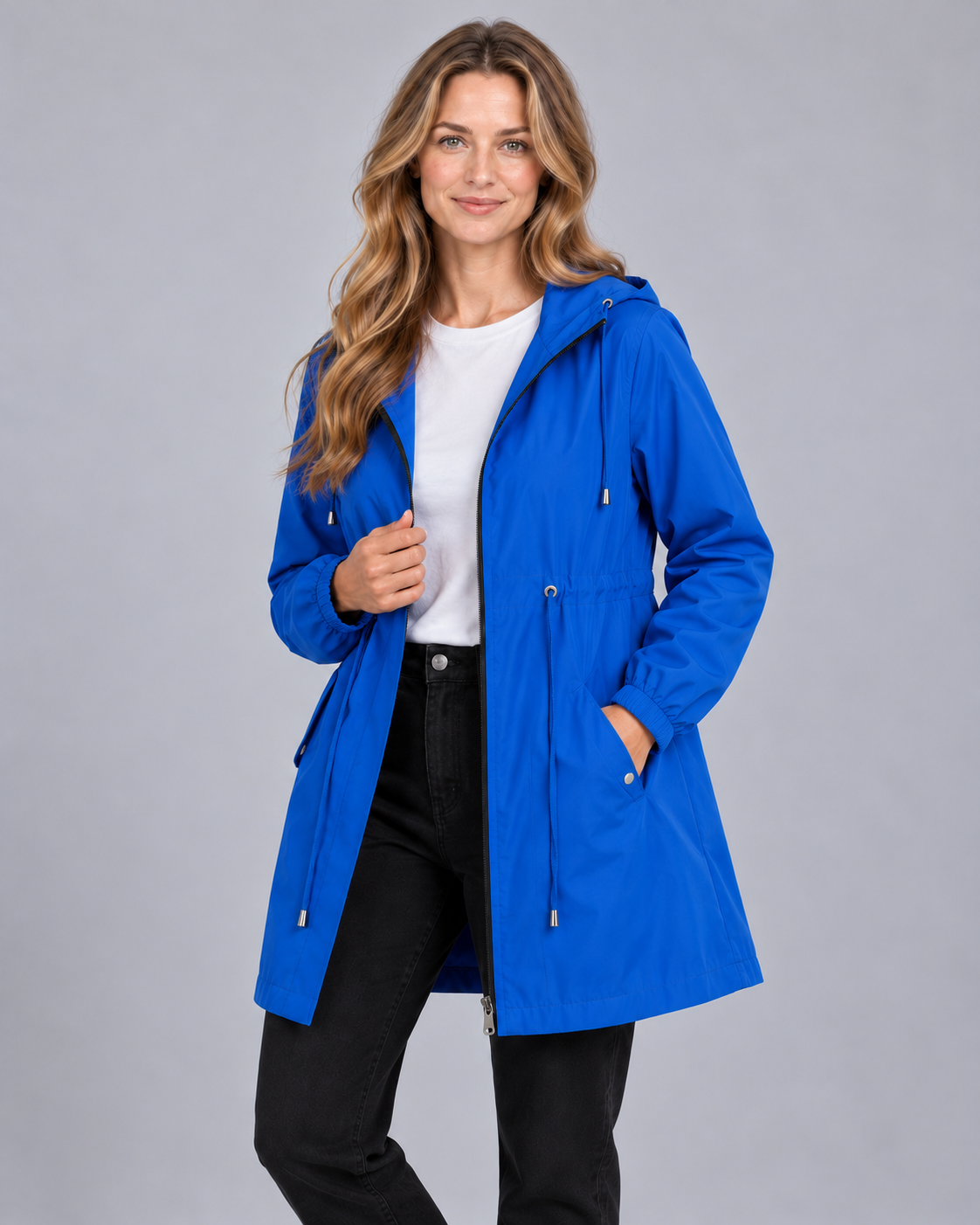 Women's lightweight hooded rain coat in blue, front view on model