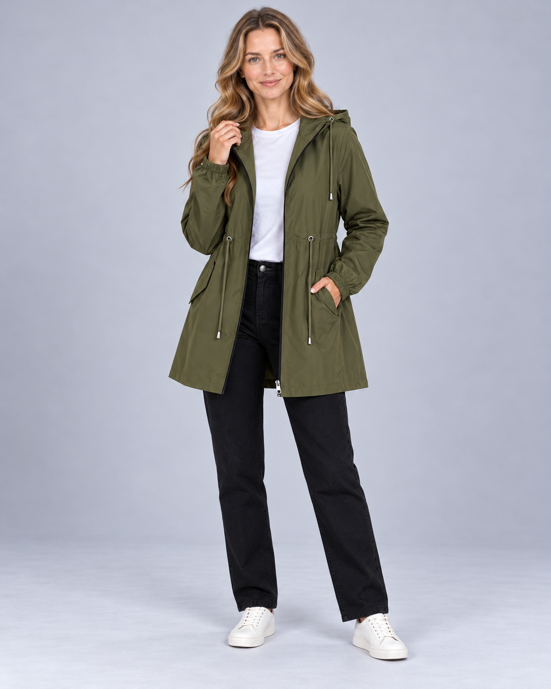 Women's lightweight hooded rain coat in green, front view on model