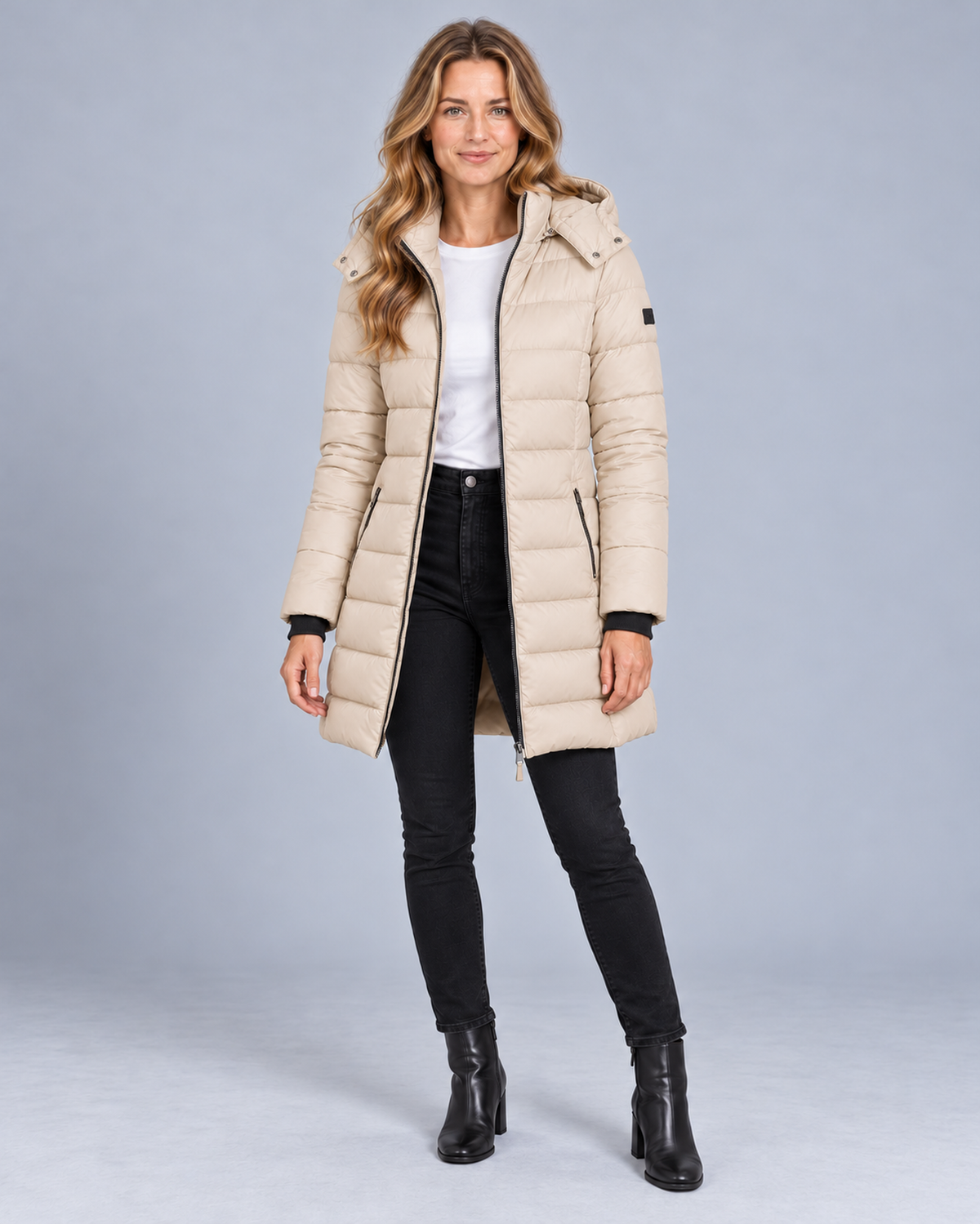 Women's long hooded puffer jacket in beige, front studio view