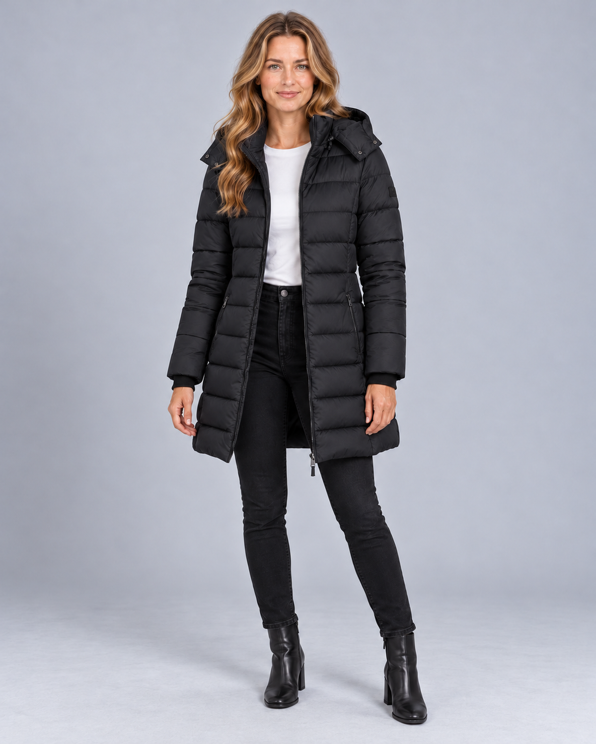 Women's long hooded puffer jacket in black, front studio view