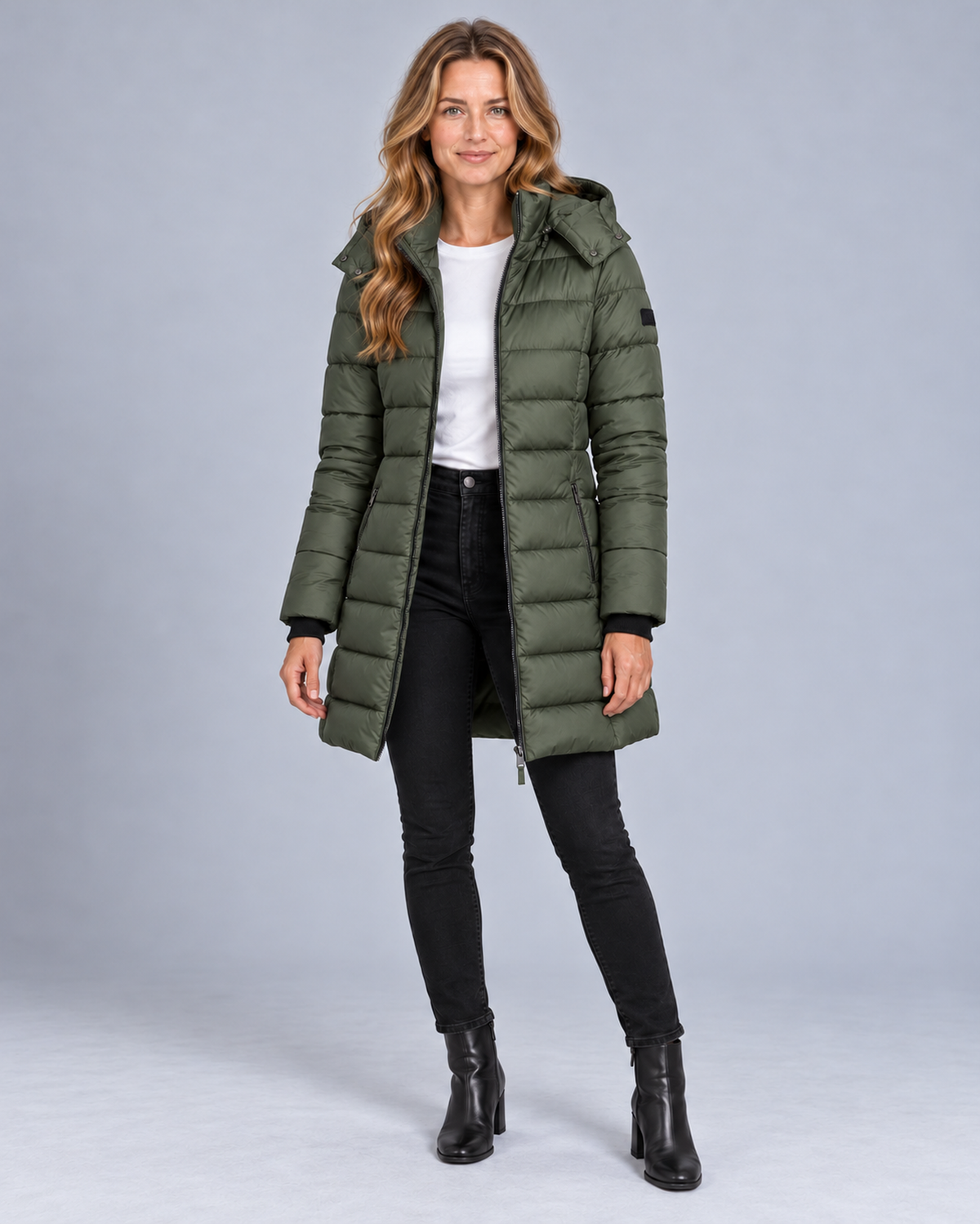 Women's long hooded puffer jacket in green, front studio view