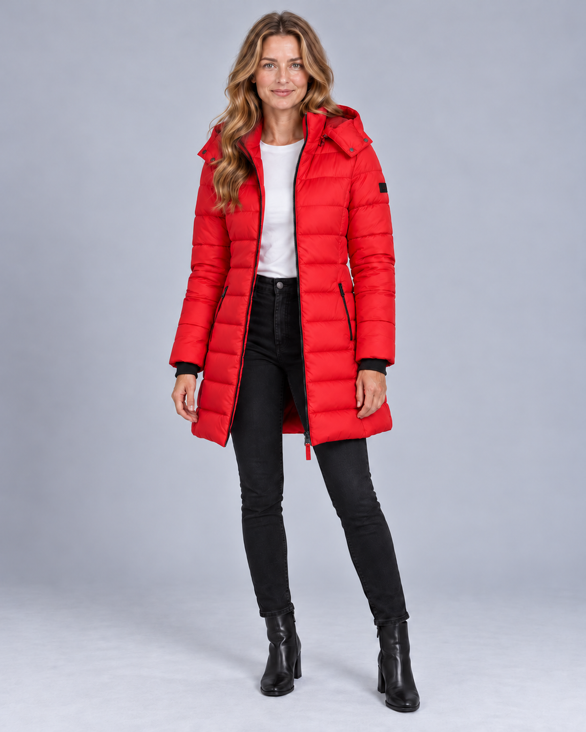 Women's long hooded puffer jacket in red, front studio view