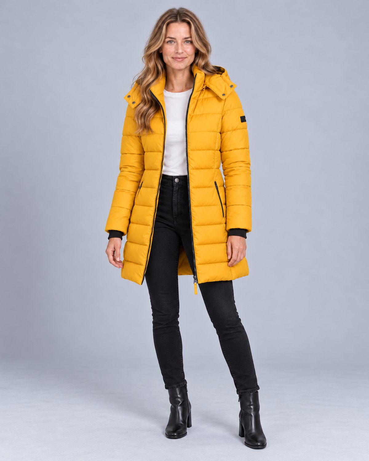 Women's long hooded puffer jacket in yellow, front studio view