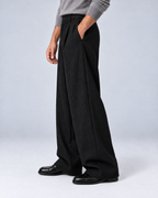 Men's black pinstripe wide-leg trousers, side