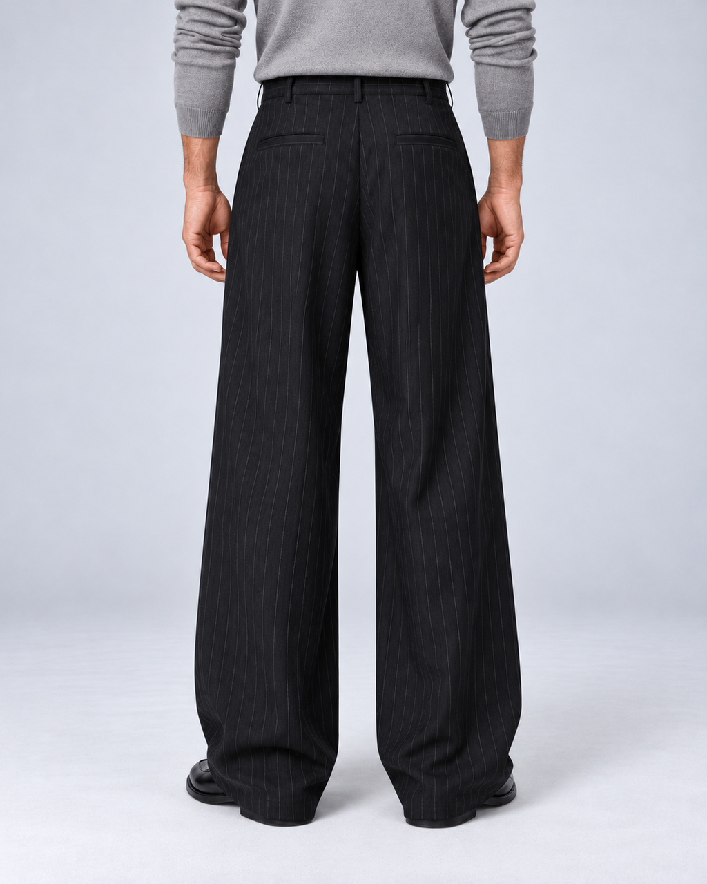 Men's black pinstripe wide-leg trousers, rear