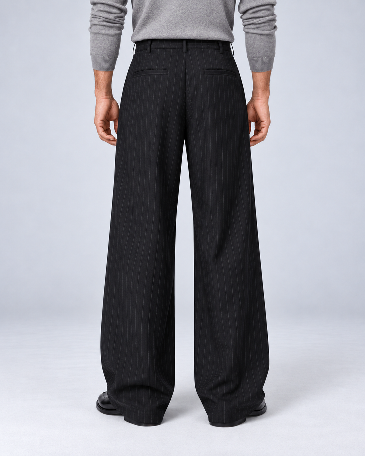 Men's black pinstripe wide-leg trousers, rear