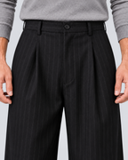 Men's black pinstripe wide-leg trousers, waist detail