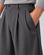 Men's grey pinstripe wide-leg trousers, pocket detail