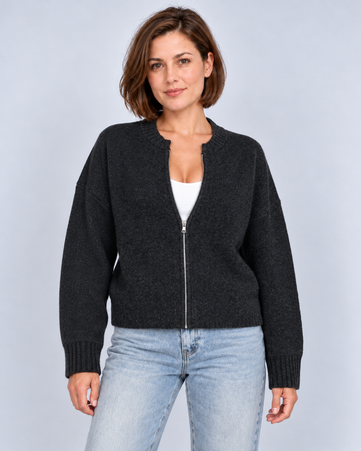 Women's drop-shoulder zip-front knit cardigan in black, front studio view