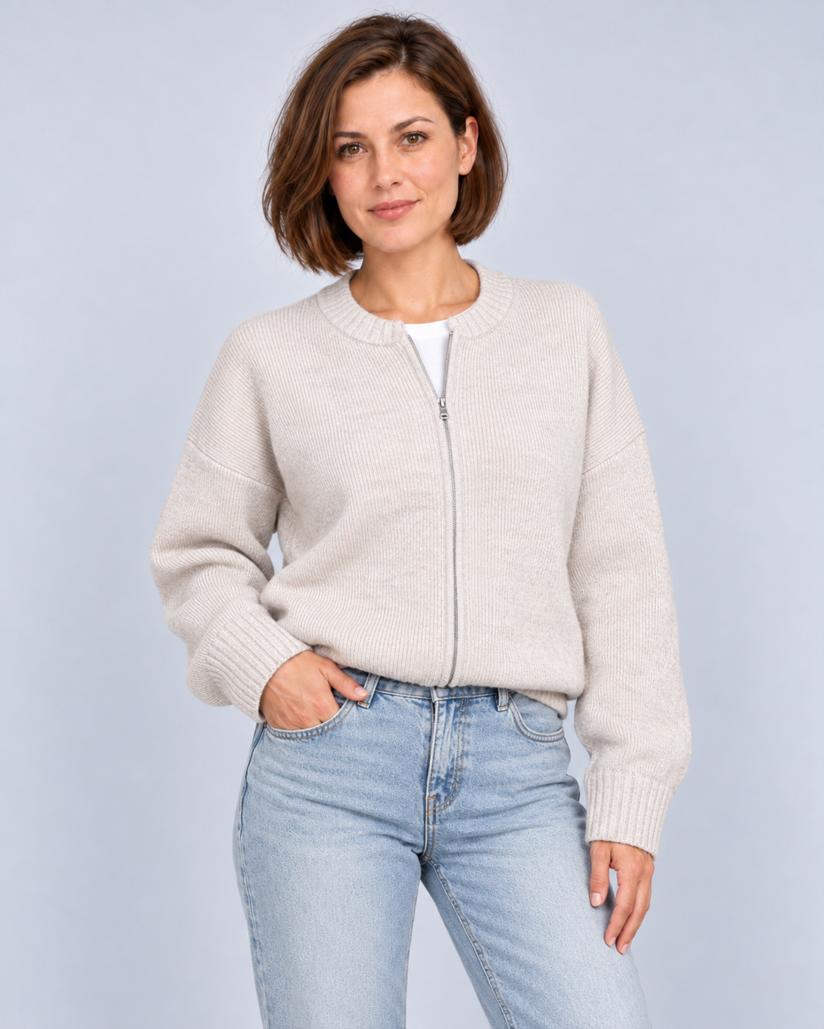 Women's drop-shoulder zip-front knit cardigan in cream, front studio view
